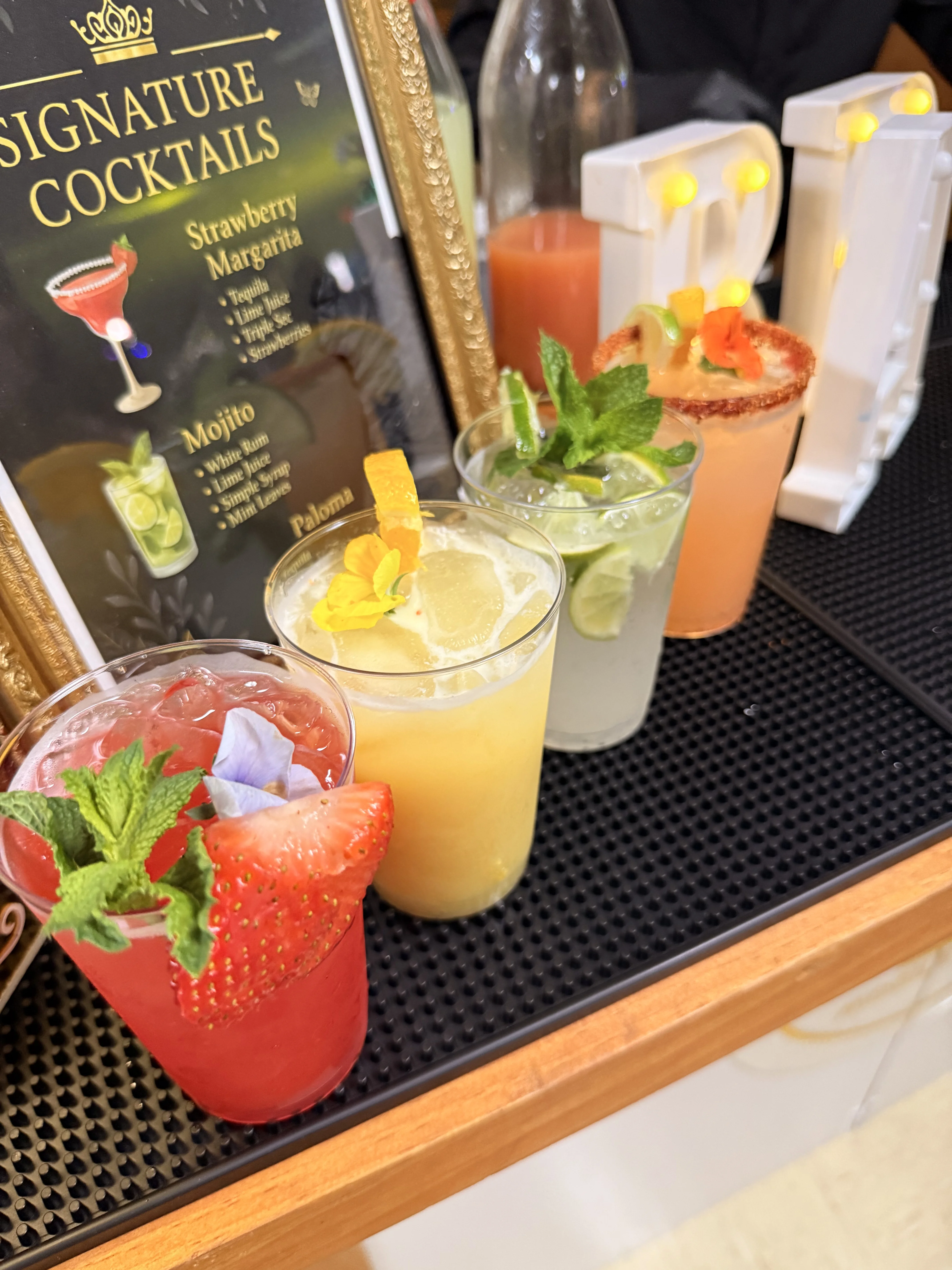 Craft cocktail being prepared and garnished by a professional bartender